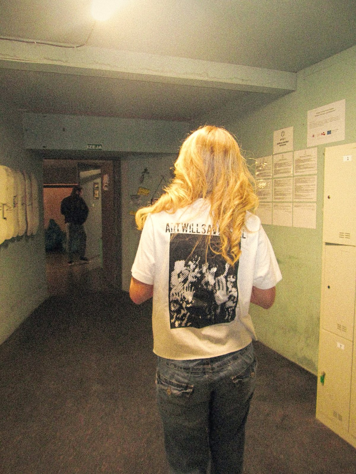 The ART WILL SAVE US ALL back print, walking down a dim corridor